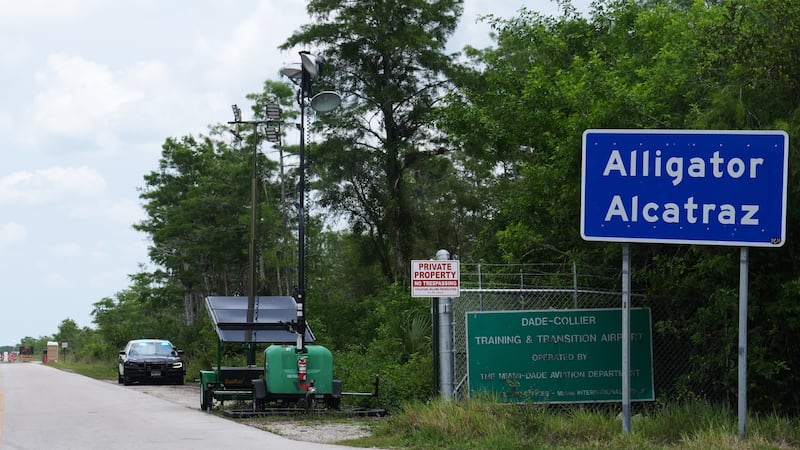 A Florida Highway Patrol car guards the entrance to the "Alligator Alcatraz" detention center...