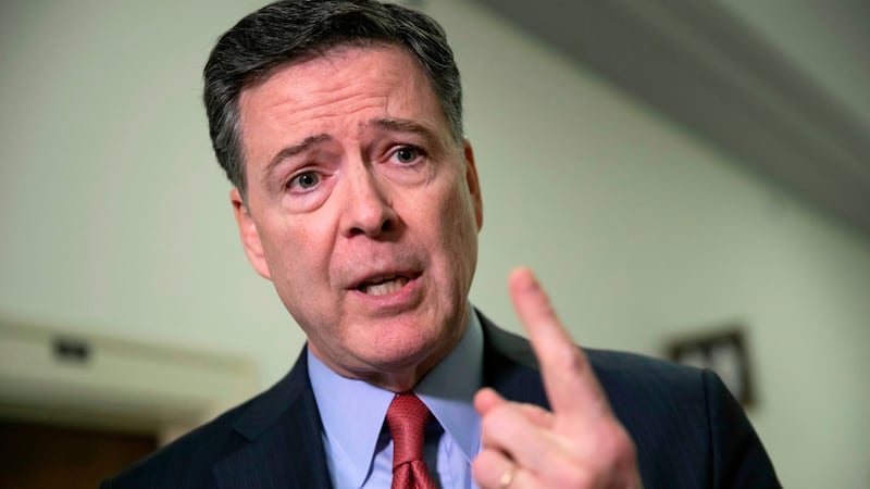 FILE - Former FBI Director James Comey speaks to reporters on Capitol Hill in Washington, Dec....