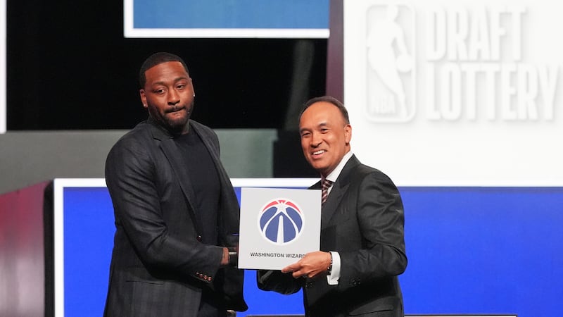 Washington Wizards' John Wall, left, and NBA Deputy Commissioner Mark Tatum, pose for photos...
