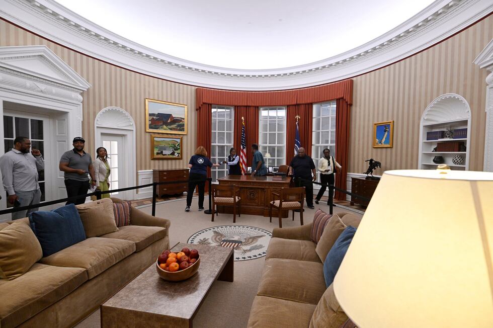 Visitors tour a replica of former President Barack Obama's oval office at the Obama...