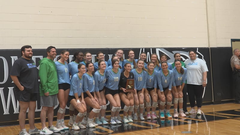 Rampants volleyball pose with 6A East regional trophy