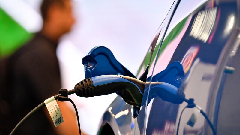 FILE - In this Friday, Nov. 29, 2019 file photo, an electric car is charged at the Essen Motor...