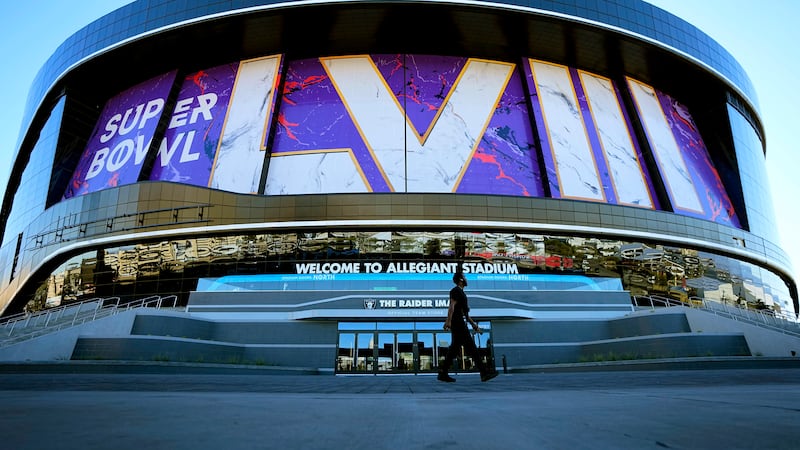 A worker walks in front of Allegiant Stadium in advance of Super Bowl 58, Tuesday, Jan. 30,...