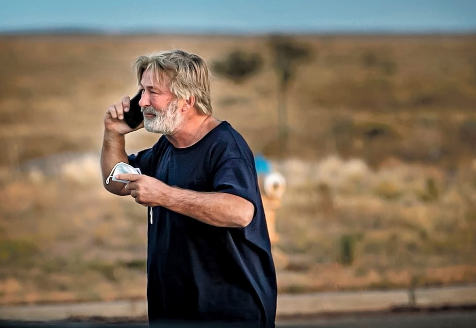 Alec Baldwin speaks on the phone in the parking lot outside the Santa Fe County Sheriff's...