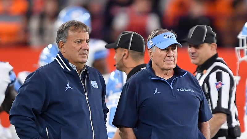 North Carolina head coach Bill Belichick, right, and general manager Michael Lombardi watch...