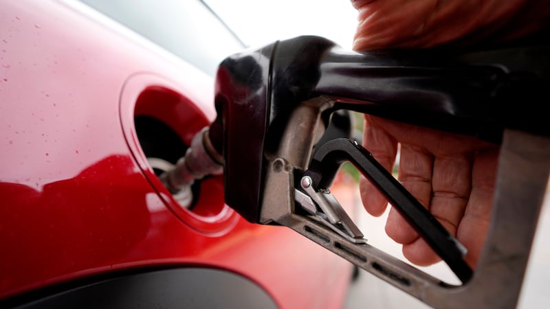 FILE - A motorist pumps fuel at a Shell station Wednesday, July 5, 2023, in Englewood, Colo.