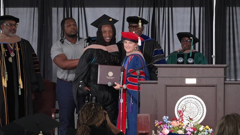 A paralyzed college graduate in Virginia used a special robotic suit to help him walk across...